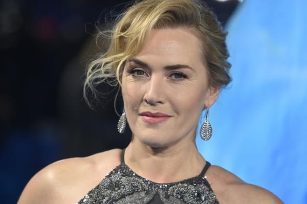 A close up of Kate Winslet in a sparkly dress and wearing earrings